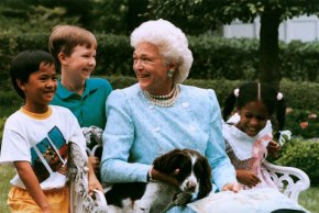 President George H.W. Bush's dog Millie, a springer spaniel, was the first presidential pet to write a book. In this photo, First Lady Barbara Bush reads a story to children with Millie.